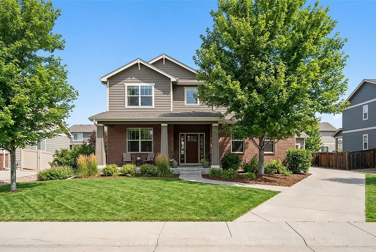 The four bedroom house at 2418 Aspen Hollow Drive, with a brick and siding front and a covered porch