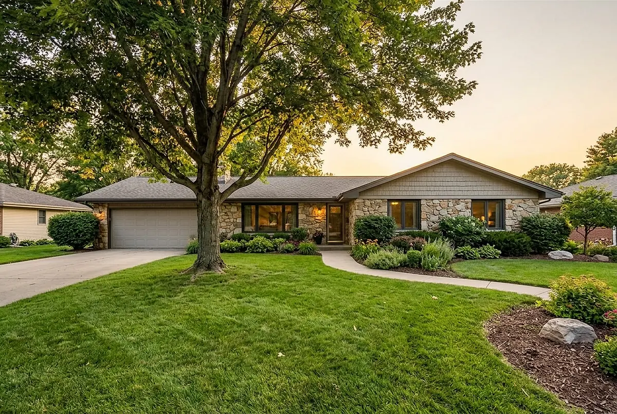 The four bedroom ranch house at 58 Elkhorn Circle, with a stone facade and a wide driveway