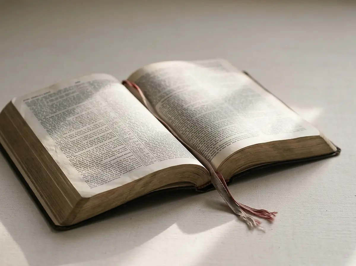An open Bible on a light table in morning light