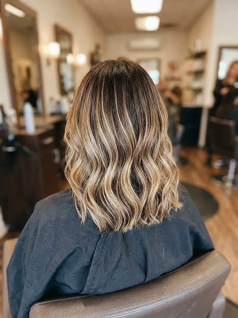 Hand-painted blonde balayage melting through shoulder-length brown hair
