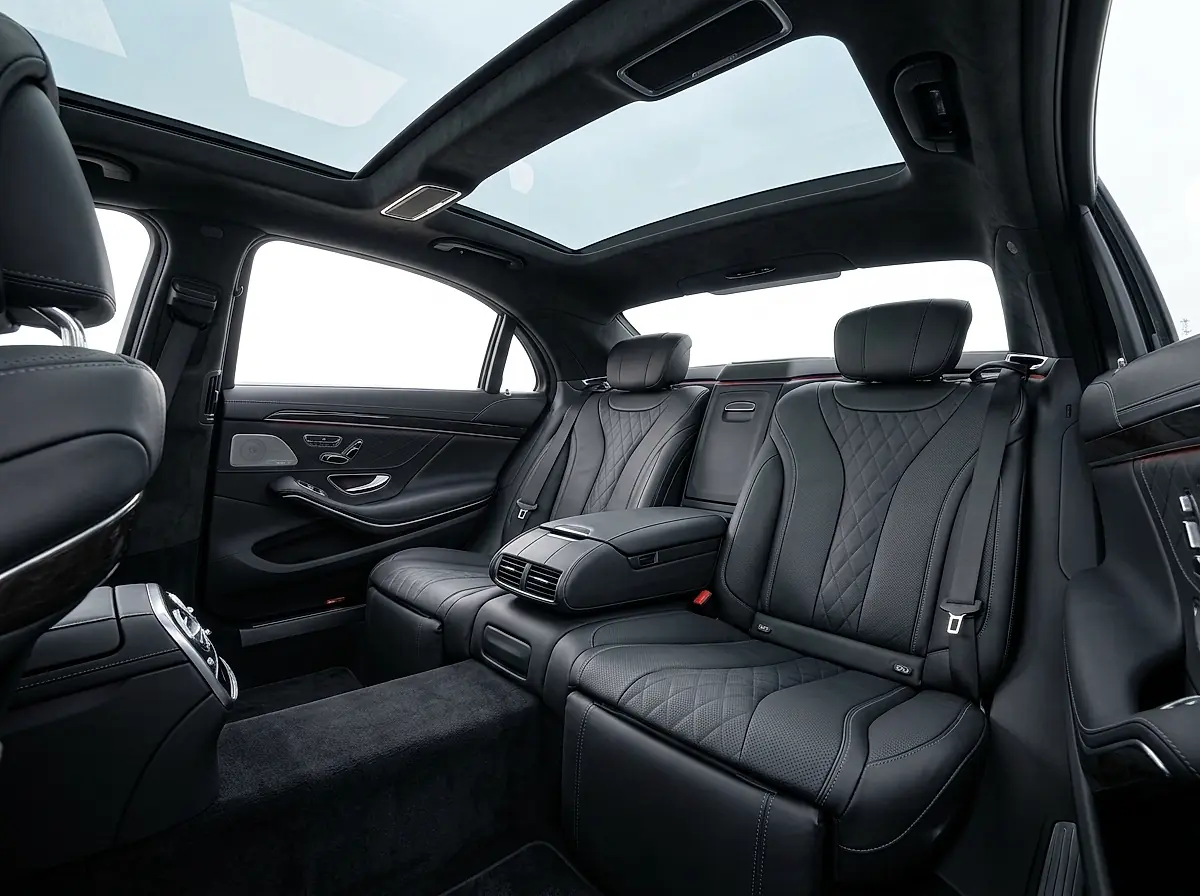 Black leather rear seats and a panoramic roof inside a European car